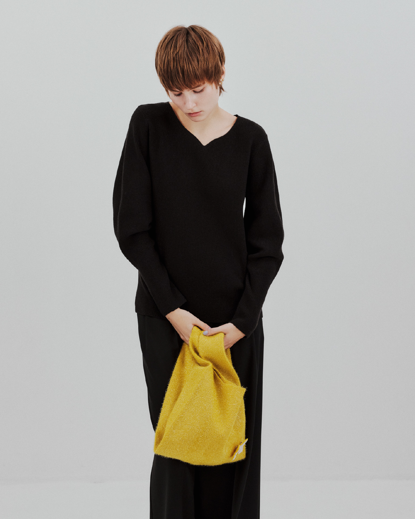 Knit Pants Pierced earrings Bag Bootsを着用するモデル