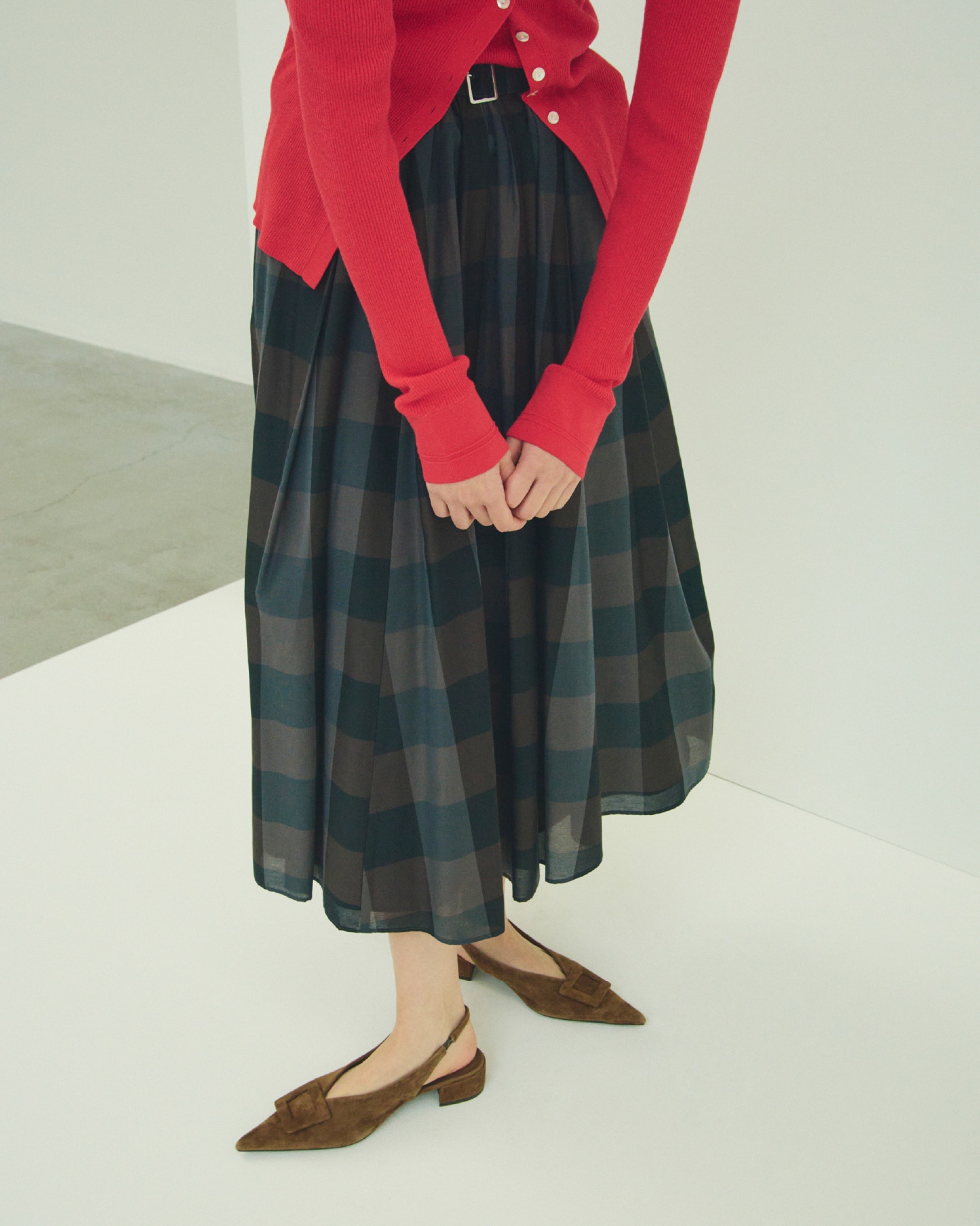赤のＵＶケアシアーリブニットカーディガンとＵＶケア半袖シアーリブニット・チェック柄のウエストゴムタックフレアスカート・モカのバックル付きラムレザースリングパンプスを合わせたコーディネート